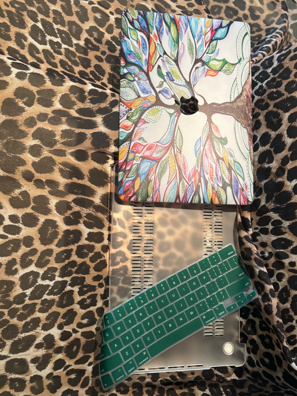 Apple Tablet with Multicolor Tree Skin and Green Keyboard Cover